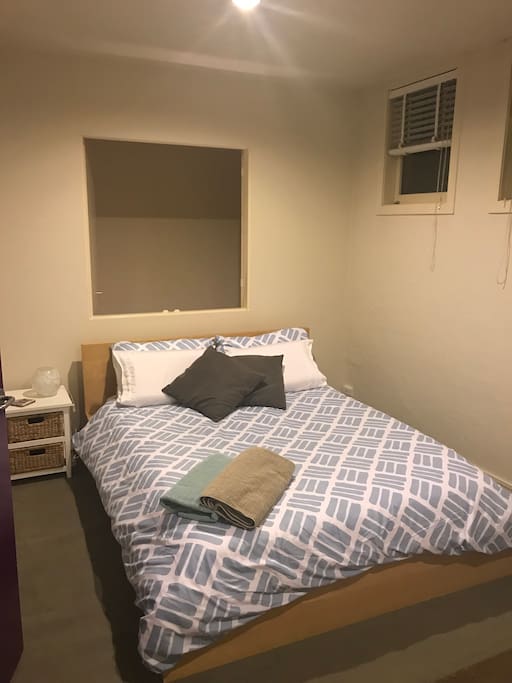 Comfy queen bed with pillow top mattress and a few different types of pillows. Desk and chair also not shown in the room.