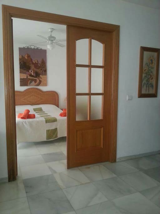 Outside Bedroom 1: wooden double doors with obscured glass