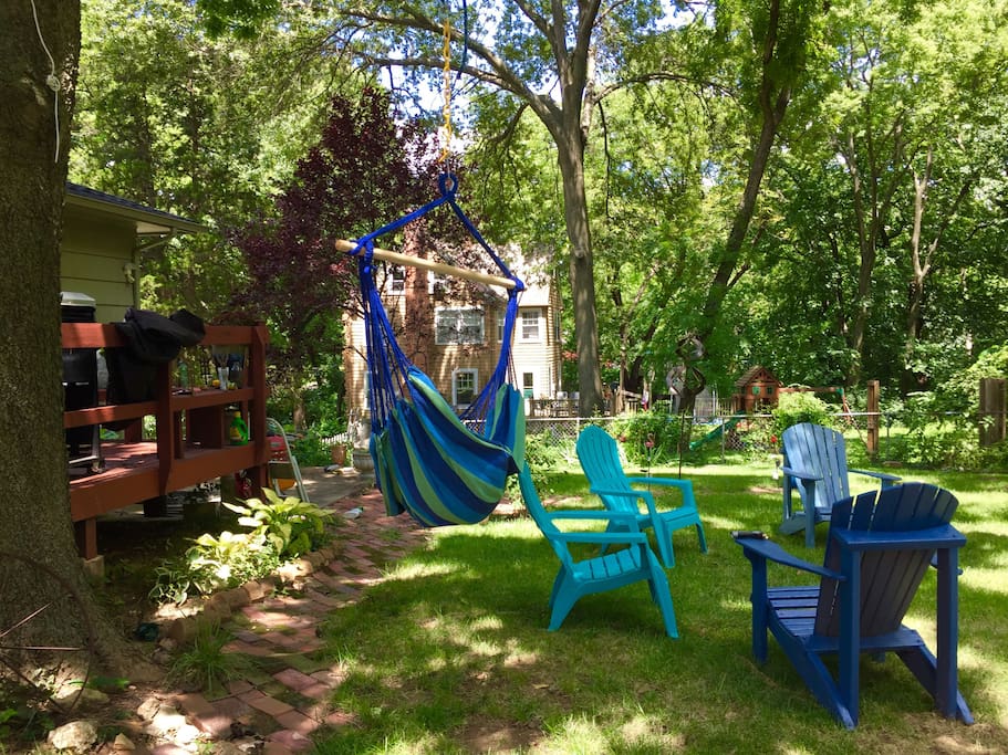 Back yard sky chair, wind sculptures, Adirondacks and hammock.
