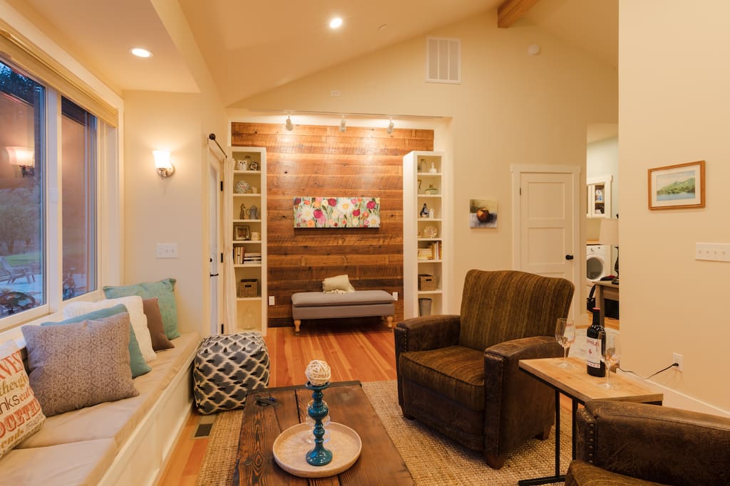 Living room, window seat, books for reading.