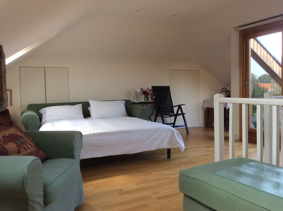 Your sofa bed open, showing table with kettle etc, fridge, + drawers with glasses, cutlery + plates, is in cupboard between bed and table. Terrace to the right.