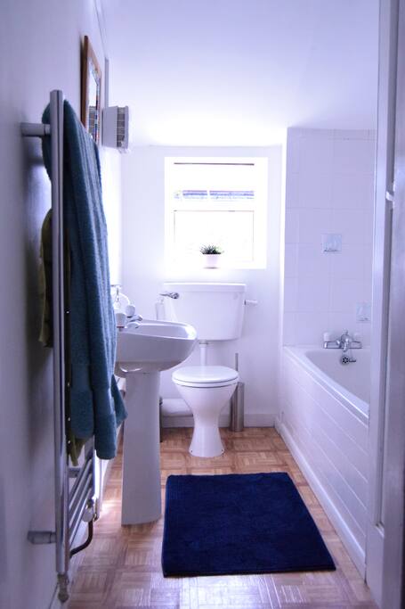 Bright bathroom with bath and shower