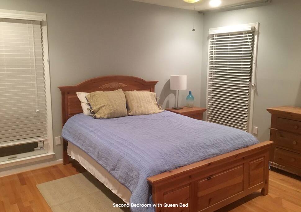 Queen bed in quaint bedroom.