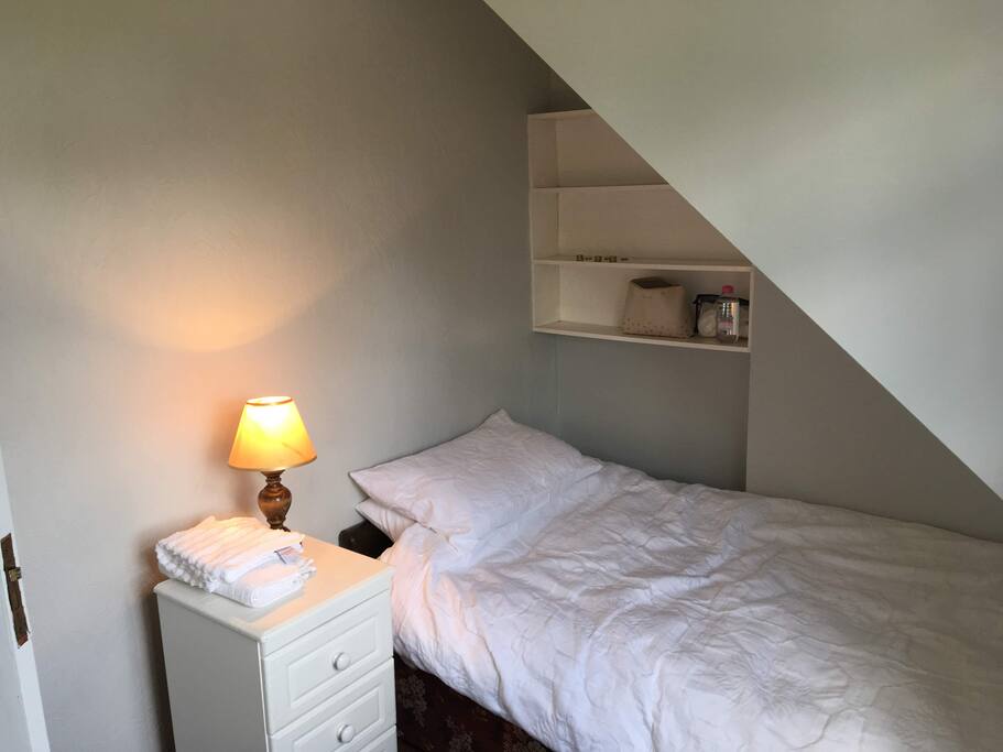 The bedroom is cute & cozy.
