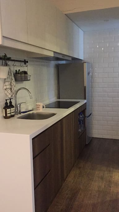 Kitchen with cookware and utensils available for use