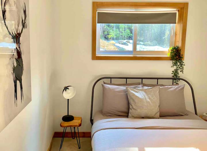 A spacious room with a comfortable double bed, decorated in soothing tones.