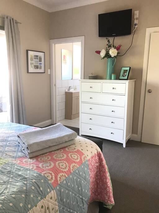 Master bedroom with ensuite. Slider doors to patio and pool. TV on wall with google chrome cast for ondemand or Netflix