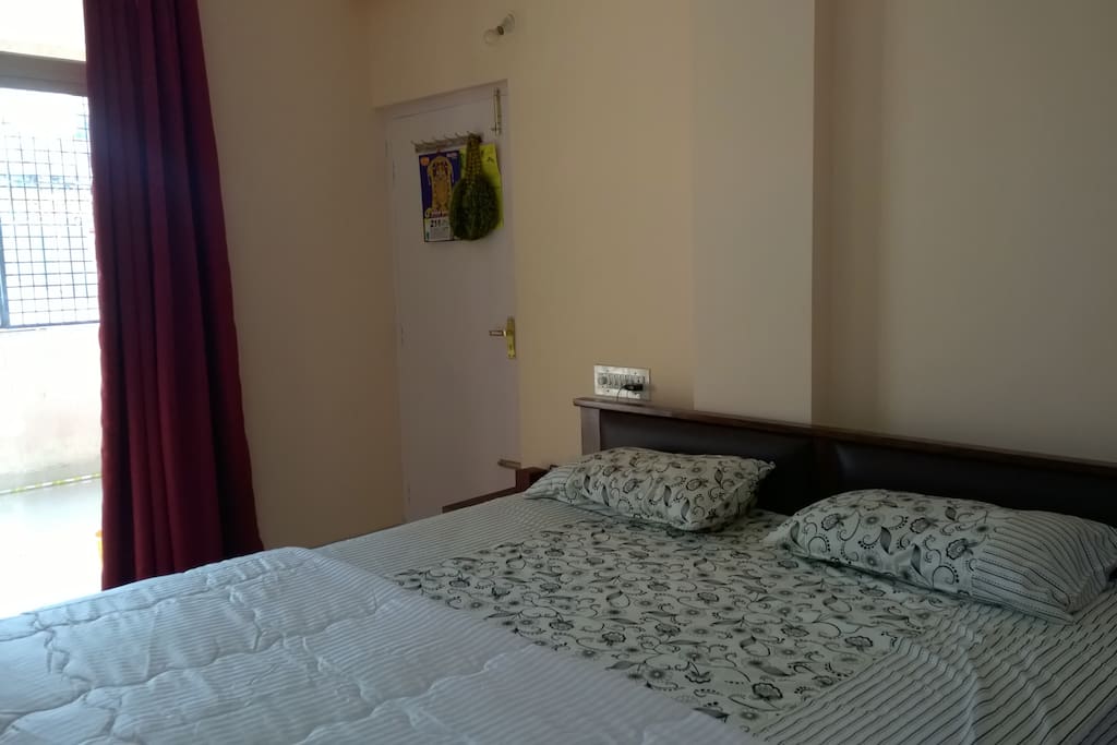 Bed room with large glazed window and curtain