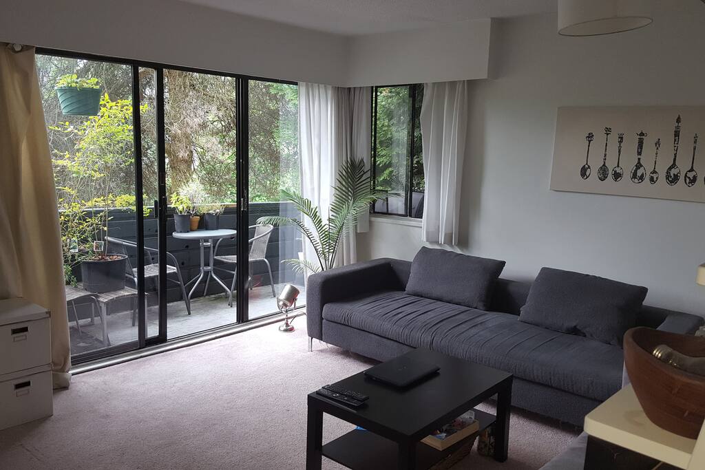Large couches with patio and bistro set.