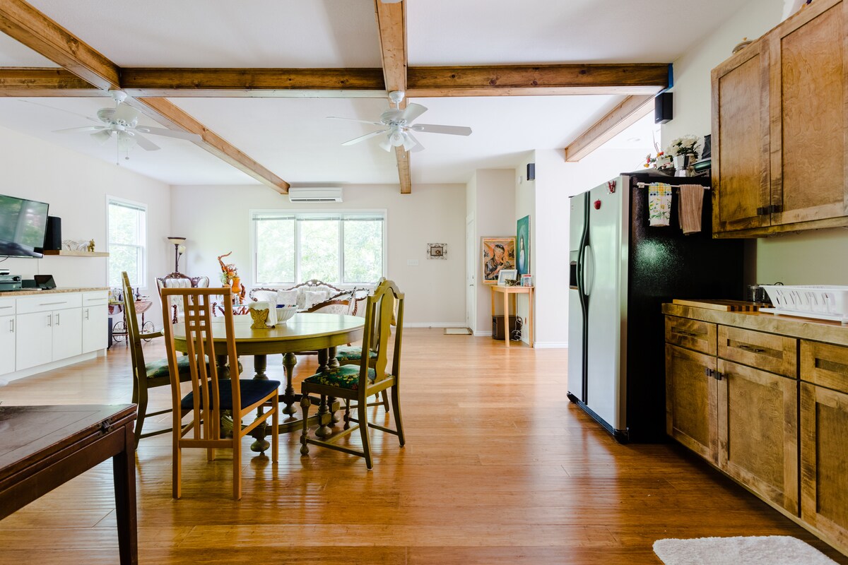 Secluded tree house apartment with high ceilings.