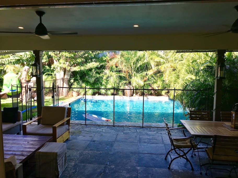 Fenced all around salt water, heated swimming pool with a self closing gate