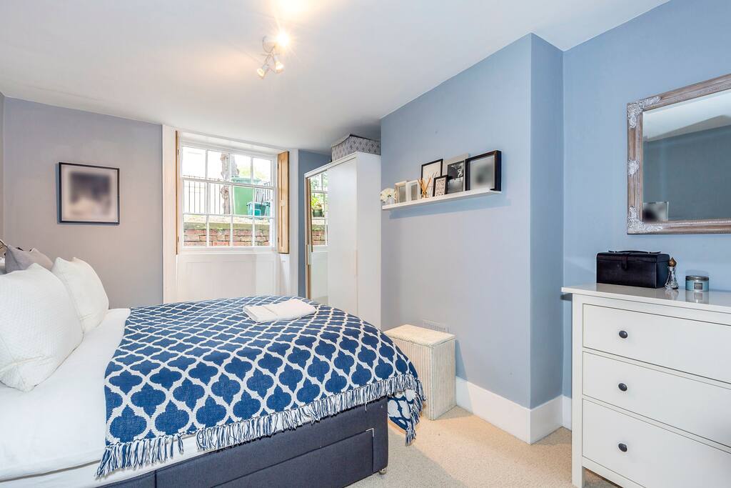 The master bedroom with an incredibly comfortable king sized bed with feather pillows and duvet.