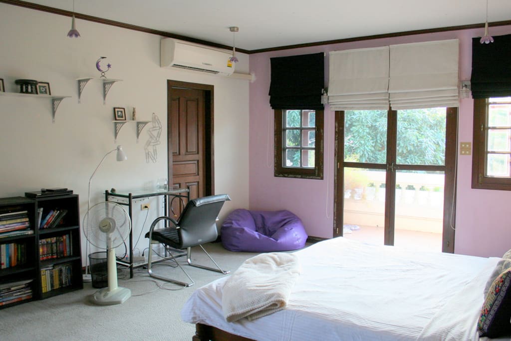 Large airy room with king size bed, desk and lots of closets.