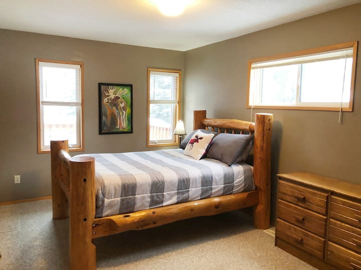 Large Main Floor Bedroom -features Queen log bed and twin size folding cot