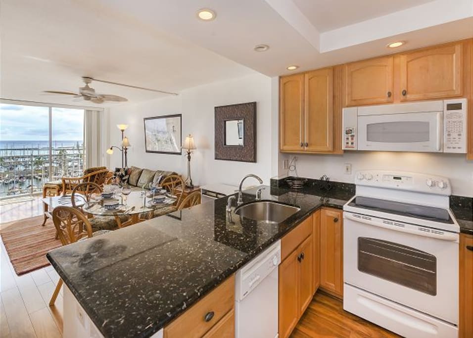 Bright kitchen with marble counters large fridge freezer and dishwasher