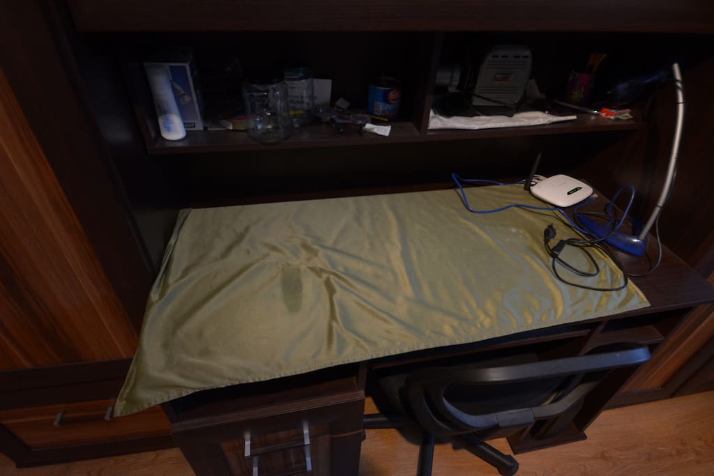 Desk with lamp and internet and chair.