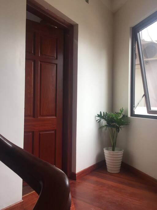Infront of the door to the studio