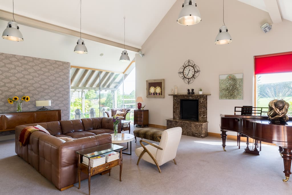 Relax in the spacious living room with open fire place and large windows