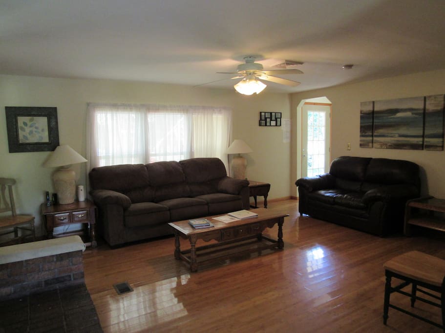 Hardwood floor, fossball table. Enclosed glass enclosed sun room overlooking water.