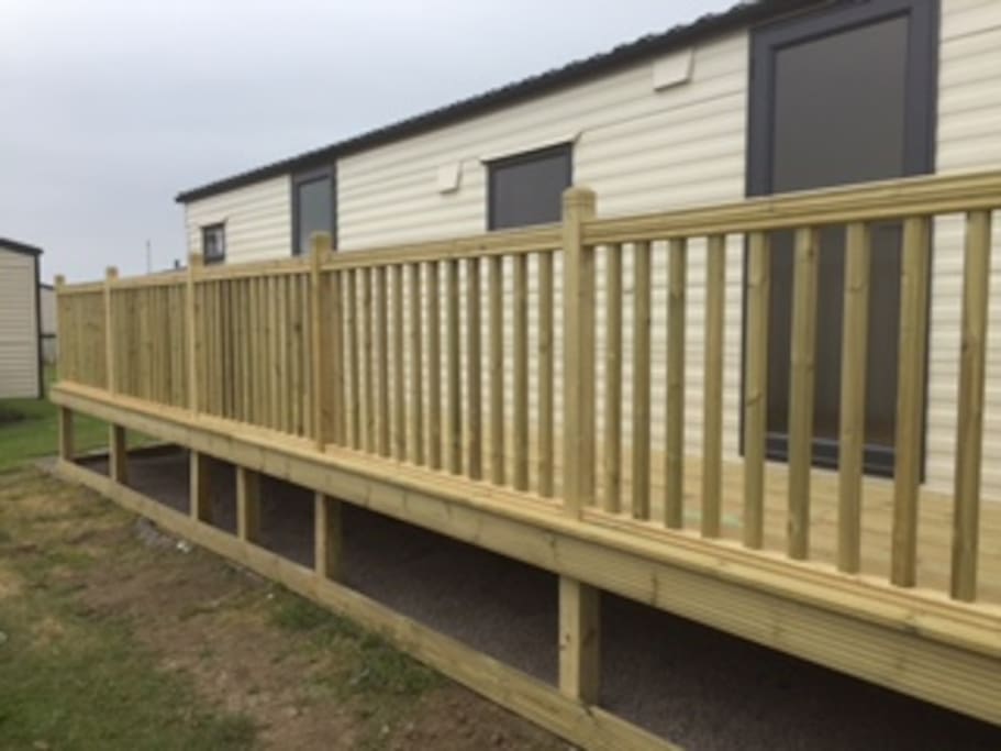 The decking is 35 ft long running entire length of caravan with a gate at one end to stop little ones escaping....