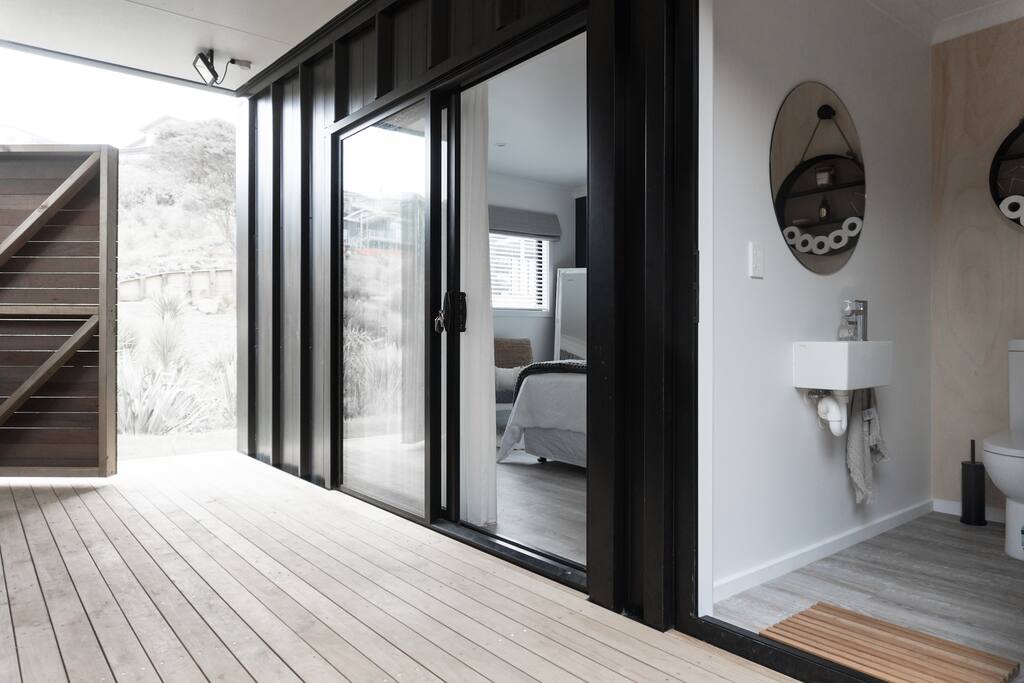 Private fully enclosed outside hot water shower to the left, Studio to the right and separate toilet.