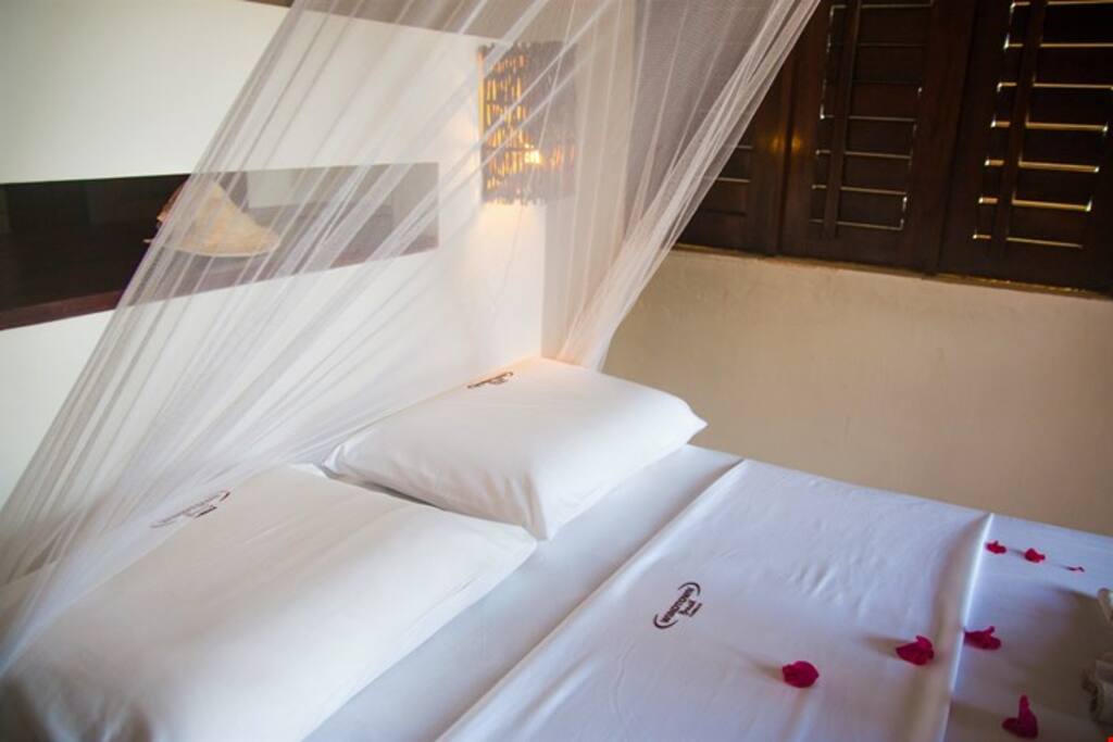 Upstairs in the mezzanine, extra guests can sleep in one of 2 single beds.