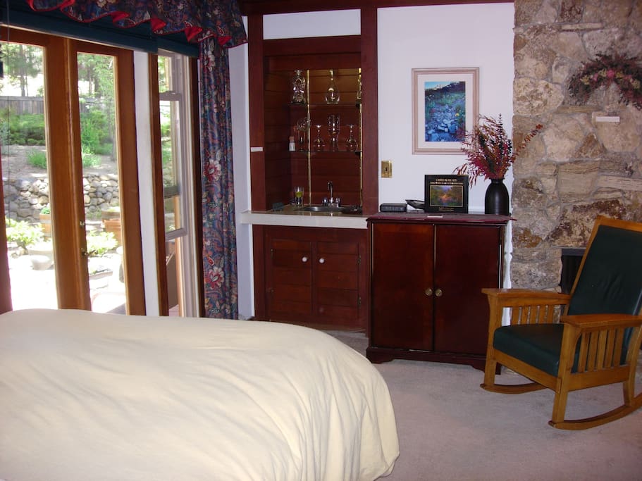 In-room wet bar, gas log fireplace, and french doors