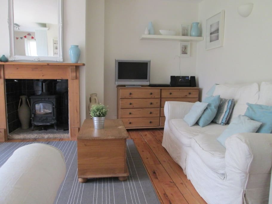 Living space with one of two settees, TV, DVD, iPod station etc