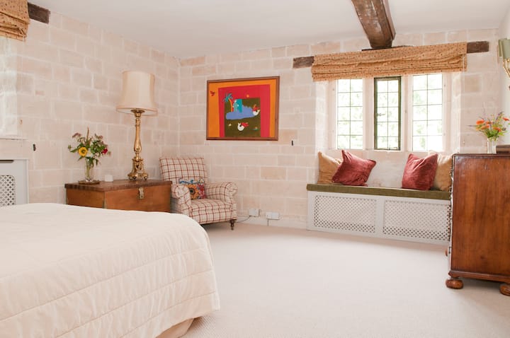 Stone Bedroom, en suite, queen sized double bed.  Double aspect onto the garden and listed dovecote.
