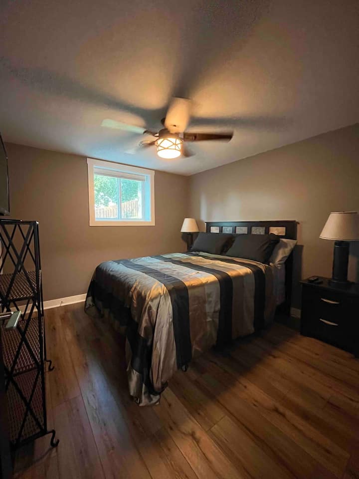 lower level queen bedroom with closet and tv