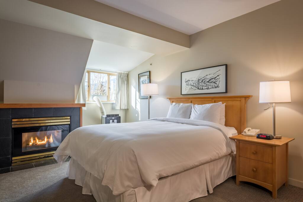 Sink into the comfortable queen bed near the fireplace.