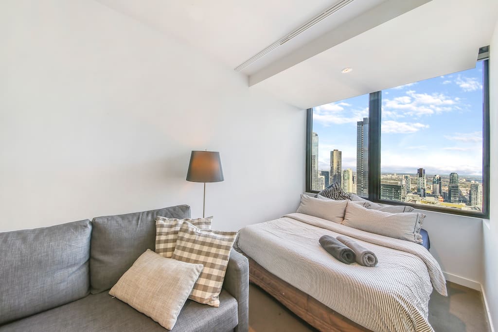 A comfy double bed with plush pillows & a magical view.