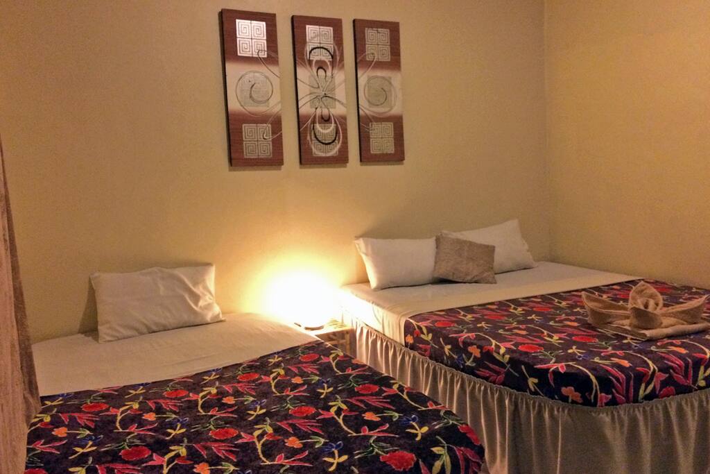 FREE Breakfast, Large Flatscreen Satellite TV, Queen Bed + Single, Large Window, Bedside Tables, Rattan Lamps. Local Balinese Artwork. Daily Cleaning is included. Towels, Toilet Paper and Soap are also included.