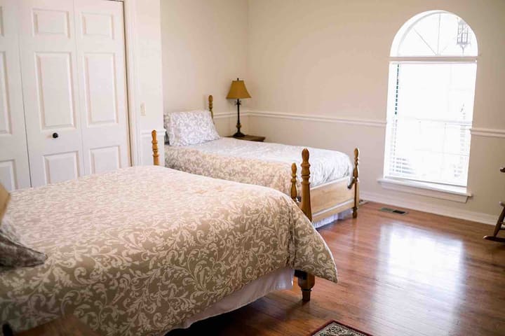 Bedroom 2, with a full bed, twin bed, and an attached shared bath.