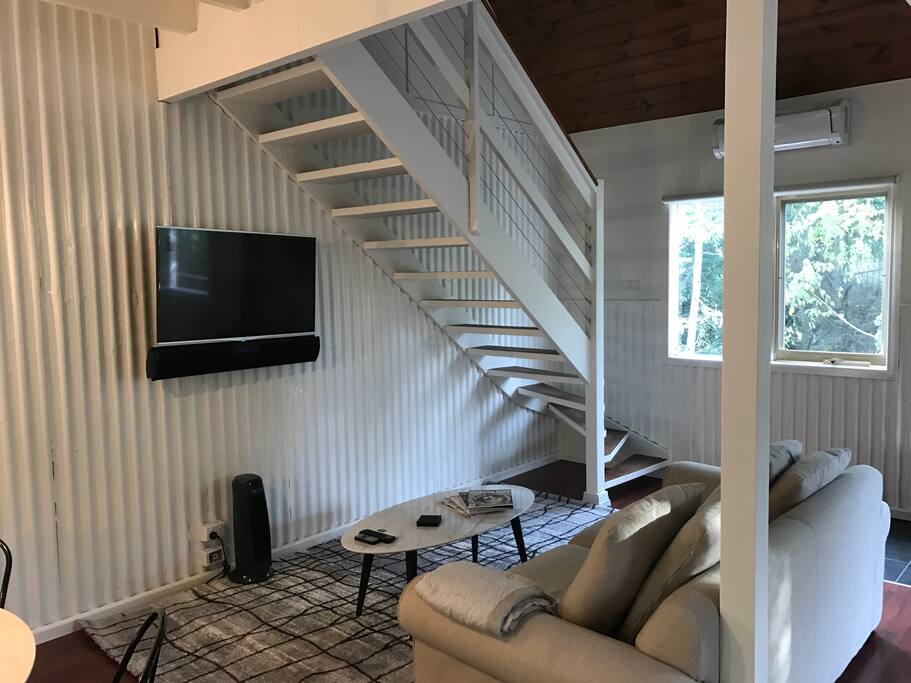 The lounge room wtih large LED television with sound bar