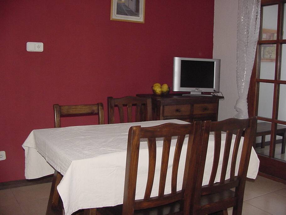 Tv dining next to terrace with traditional furniture.