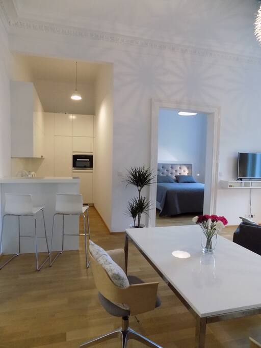 The fully equipped kitchen is connected to the living room. For diner or lunch you can sit at the bar counter or use the large dinning table.