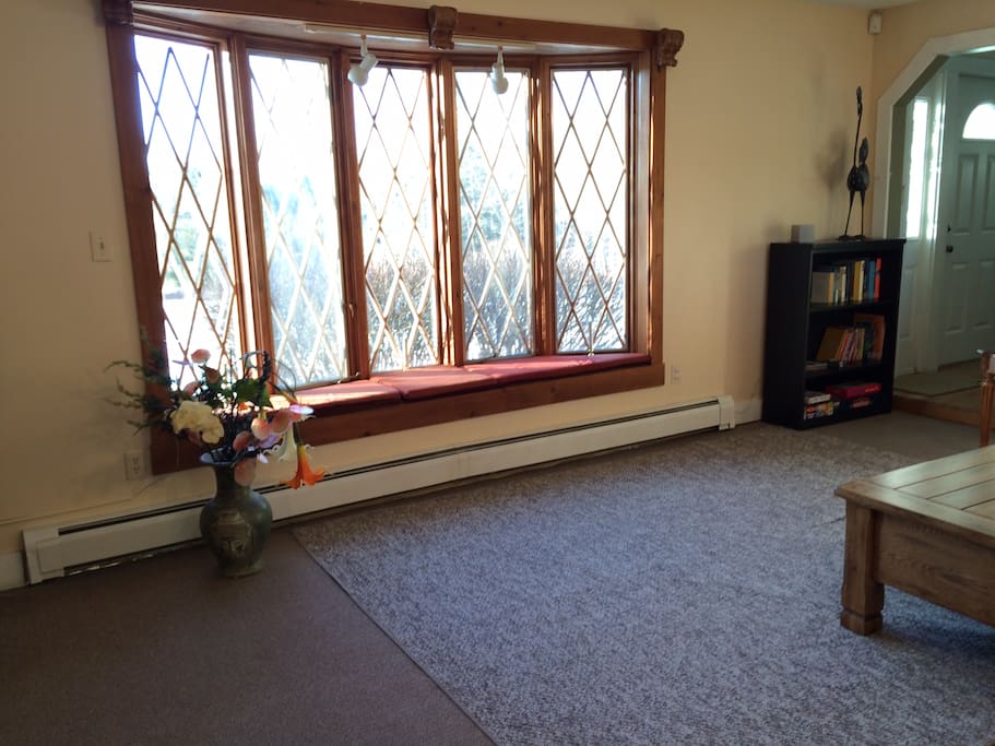 Living room window seat and bookcase with games and books