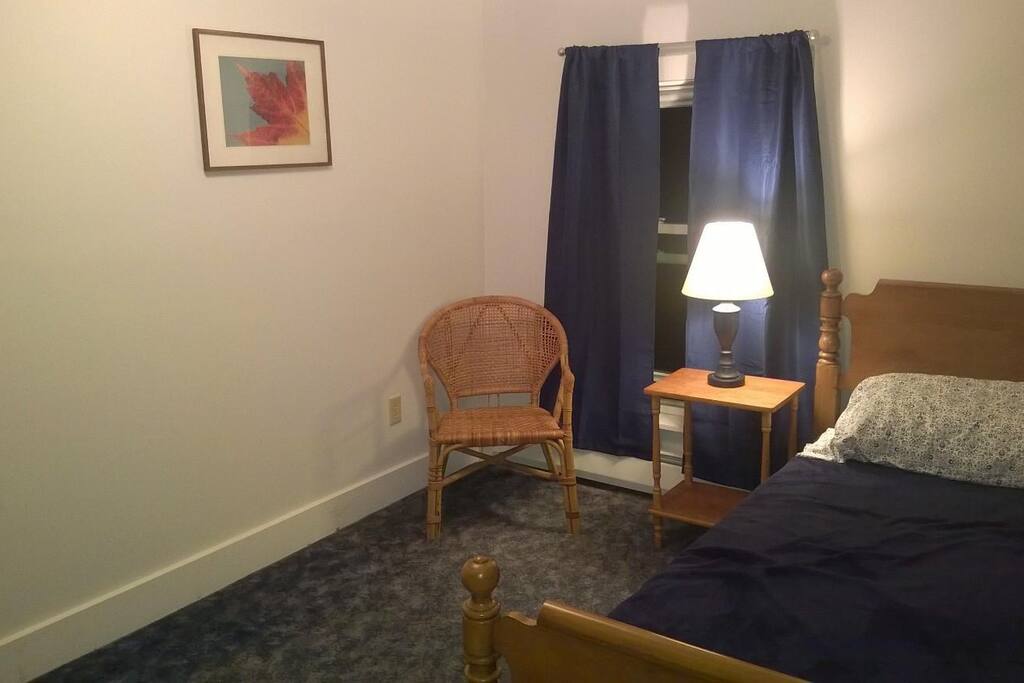 Guest room includes bed, table and lamp, chair, storage armoire, as well as optional desk.