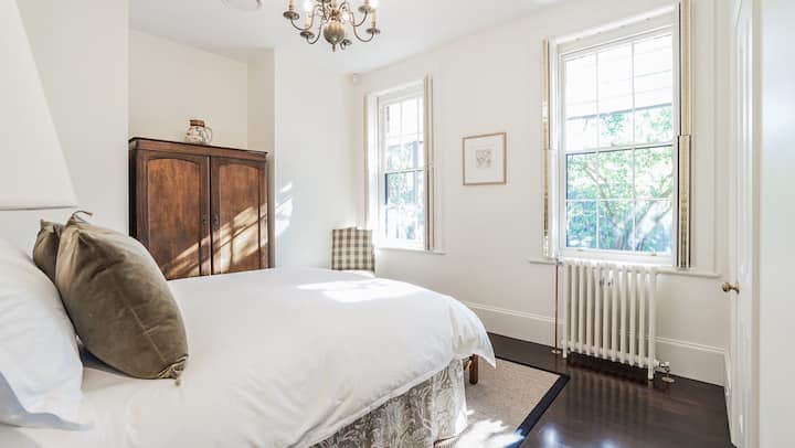 The David Unaipon bedroom is flooded with afternoon sun. The windows provide a view over the newly installed fernery garden.