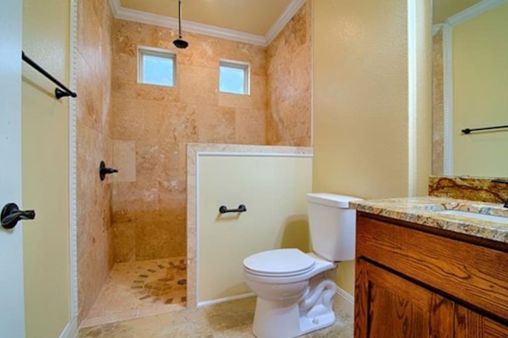 Bathroom includes L'Occittan toiletries and clean towels.