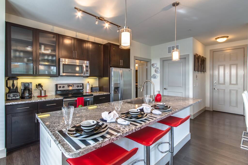 Stylish fully equipped kitchen with granite counters and stainless appliances