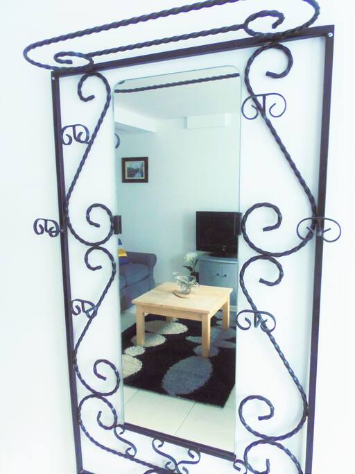 Ornate coat rack reflecting the lounge