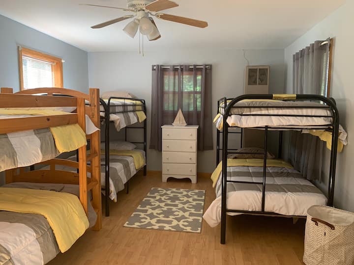 3 sets of bunk beds in bedroom 3 includes closet storage, dresser and overhead fan. 