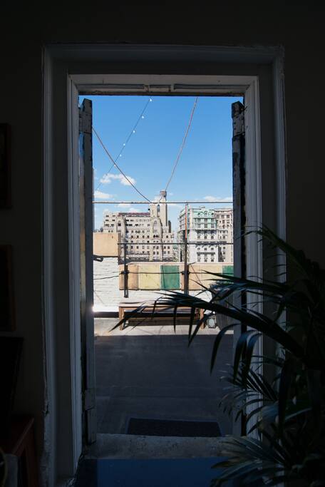 Vintage French doors lead to the wrap-around terrace