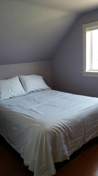 upstairs bedroom with closet and dresser