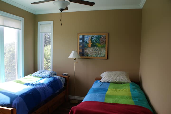 Secondary guestroom with two twin beds and views to the southeast and southwest.
