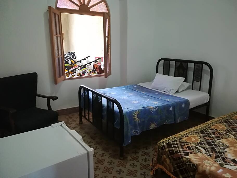 View of the room from the entrance door, with the window towards the living room open.