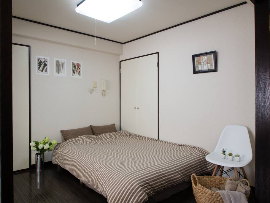 Bed Room 2 has a chair and a closet with hangers.