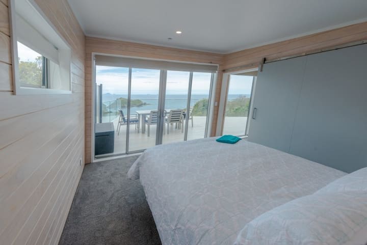 Bedroom with queen bed looking  out to beautiful  views